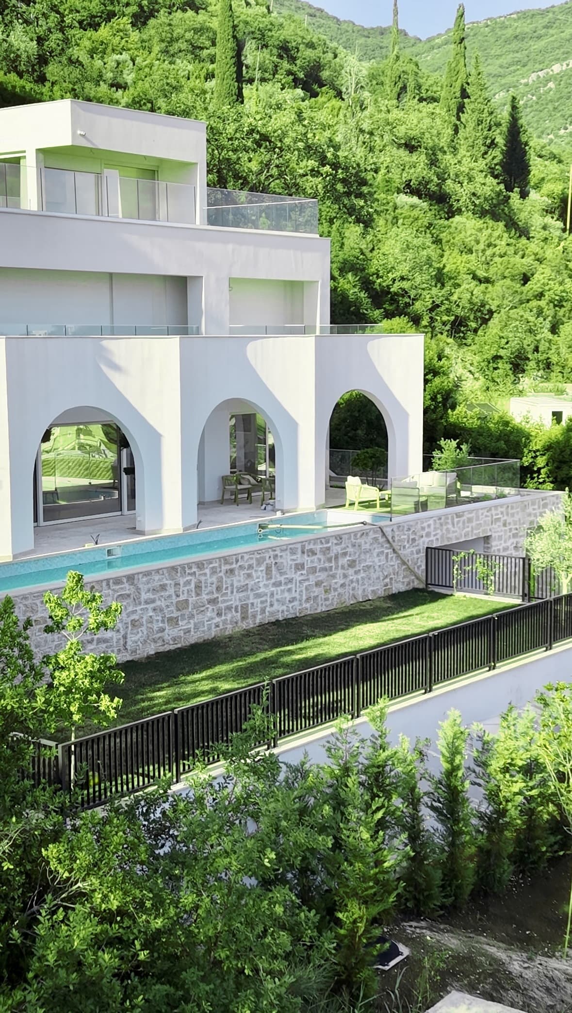 White arches and infinity pool overlooking the Bay of Kotor